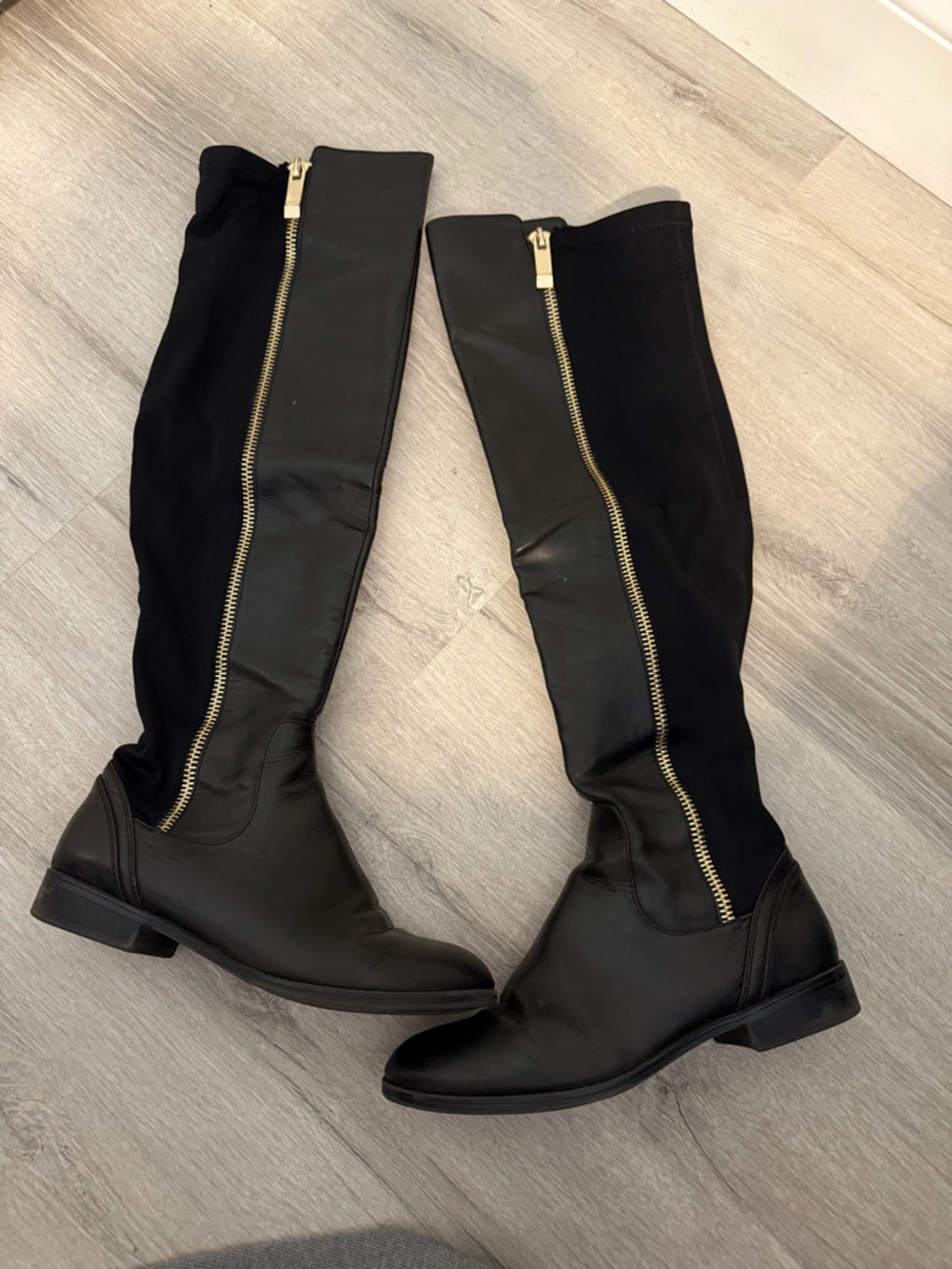 Black Over-the-Knee Boots with Gold Zipper Detail